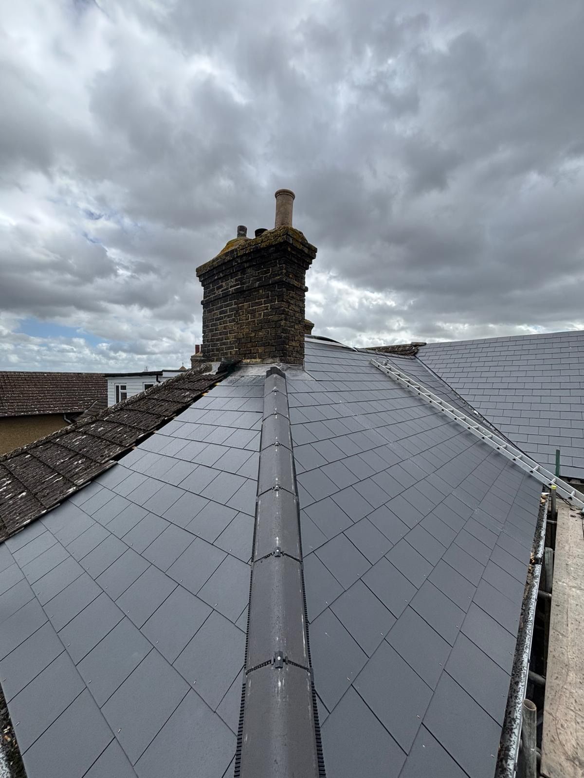 New slate roof around original brick chimney